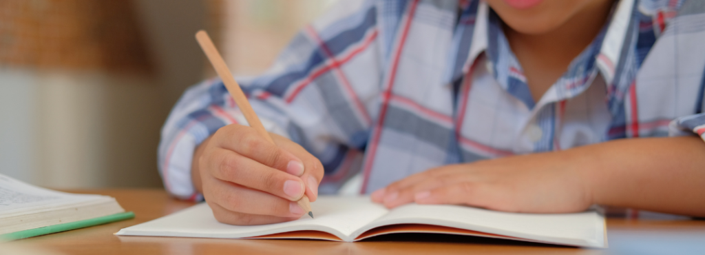 A child writing in their workbook is a valuable part of early education.